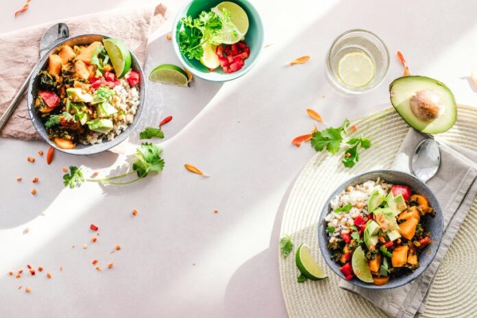 Dos platillos sobre la mesa con recetas de ensaladas distintas.